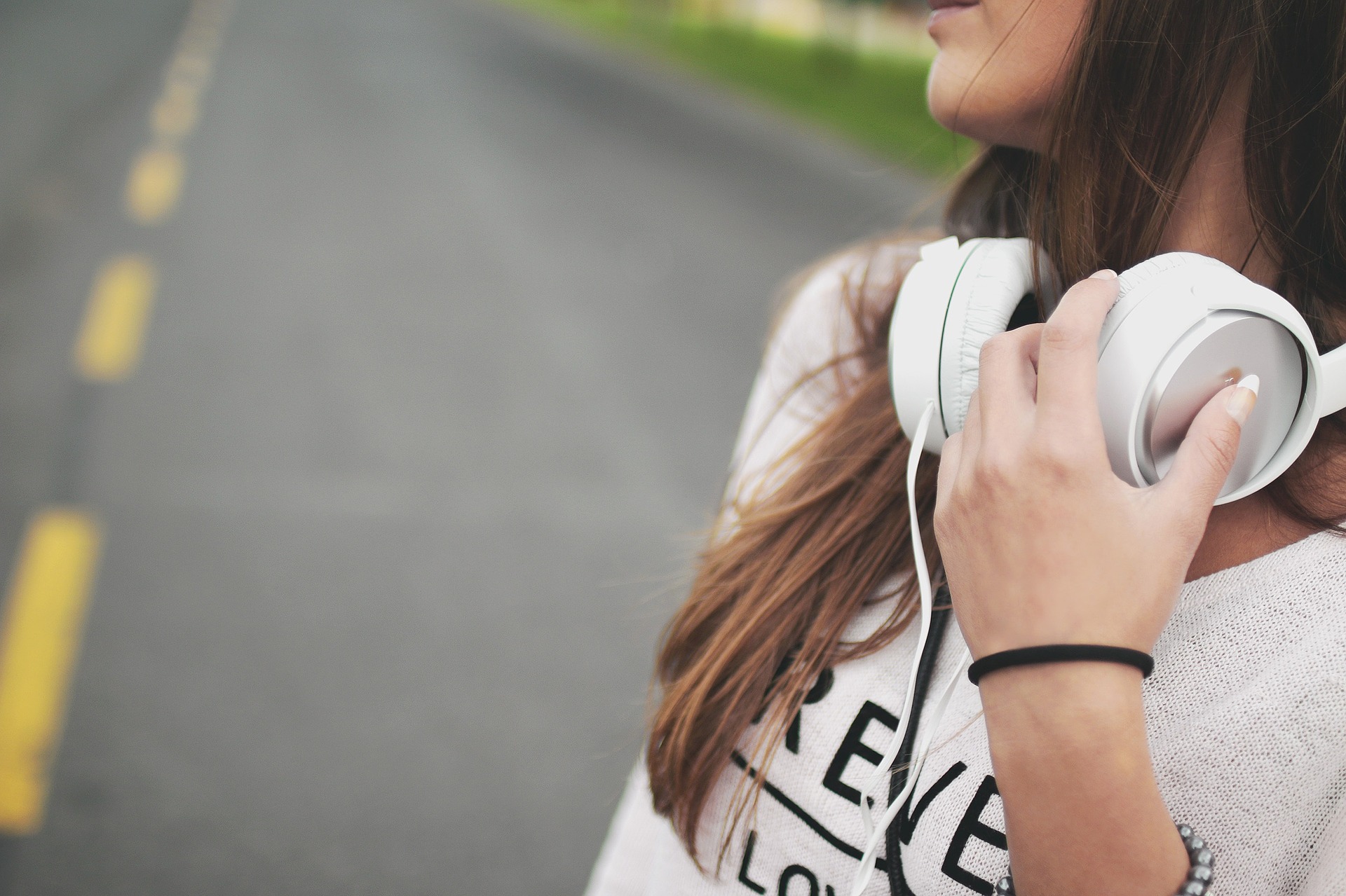 image of girl wearing headphones from blog on staying safe as a student in Sheffield 