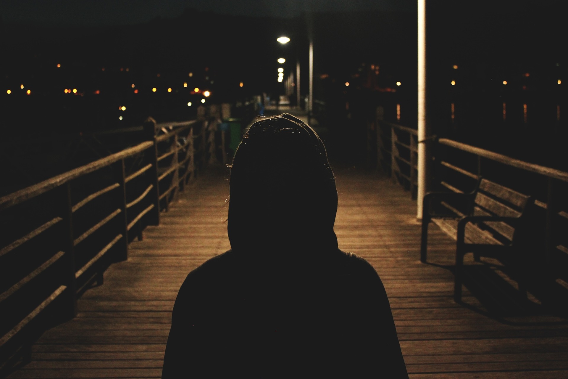 image of girl on a harbour in the dark for a blog on staying safe as a student in Sheffield 