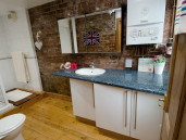 Bathroom with freestanding shower and vanity unit - Thumbnail
