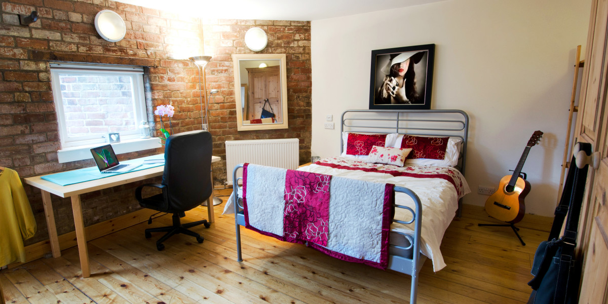 Bedroom 2 with hardwood floor, double bed and study space.