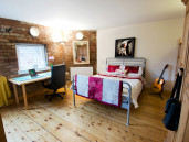 Bedroom 2 with hardwood floor, double bed and study space. - Thumbnail