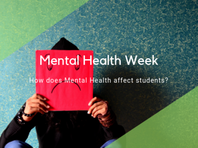 Man holding up a sad face card for mental health week